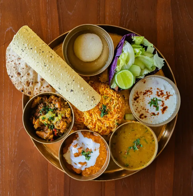 Vegetarian thali with dal, curries, rice, roti and papad served at Bali Yoga Retreats