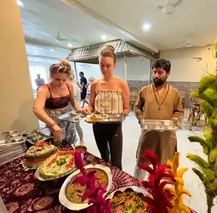 People grabbing food from a large buffet