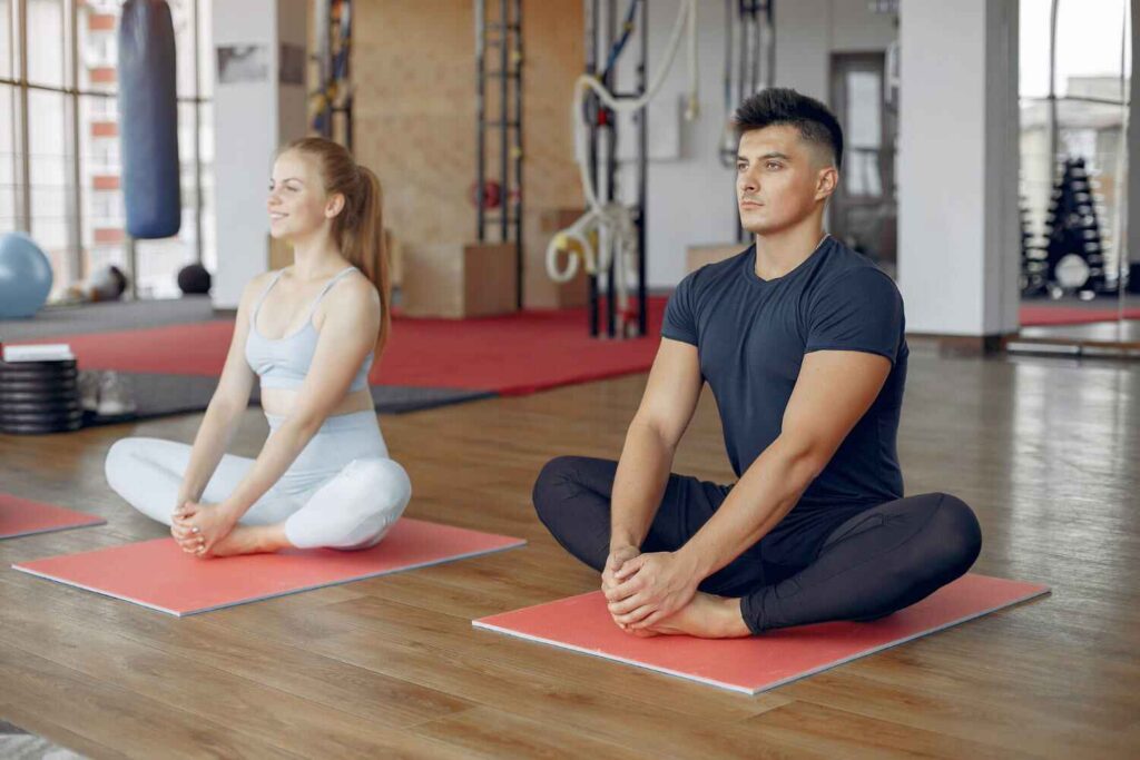 man and women practicing yoga man and women practicing yoga
