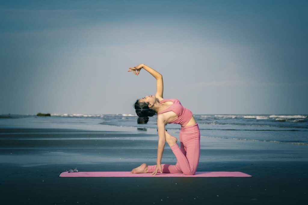 women practicing yoga in near sea women practicing yoga in near sea
