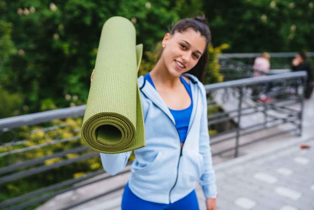 Women Holding a Yoga Mat