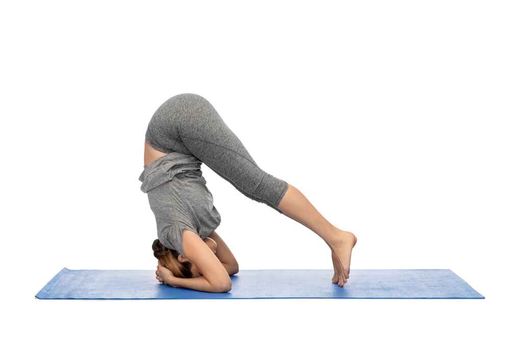 Woman in Head-To-Ground Yoga Pose Woman in Head-To-Ground Yoga Pose