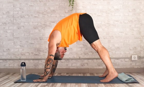 A Man Practicing Downward Facing Dog Pose