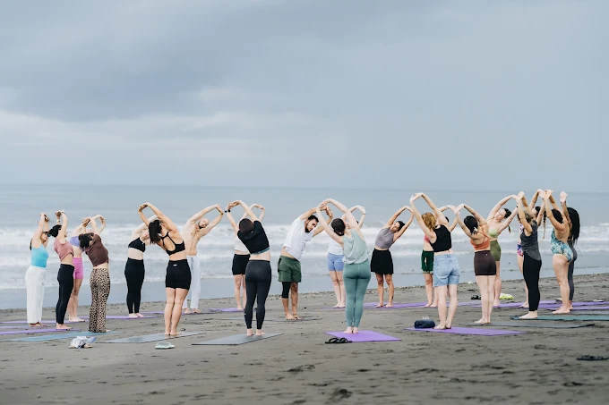 Yoga students performing stretching exercises and experiencing the Benefits of Daily Yoga