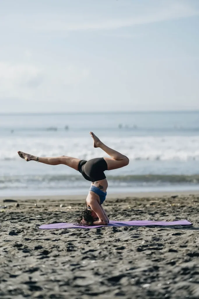 A Woman Performing Yoga at Beach 