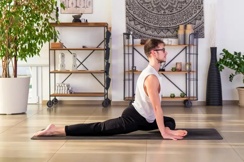 A Man Practicing Half Pigeon Pose