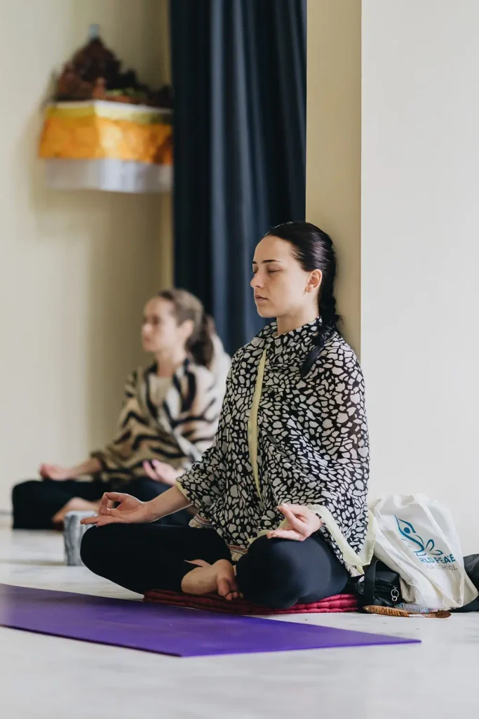 Woman practicing meditation in a yoga class for stress relief